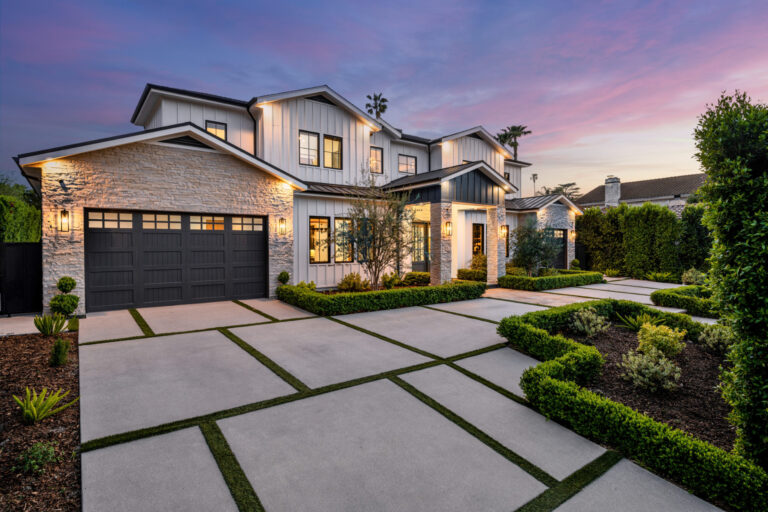 an outdoor front yard area with a path between two houses